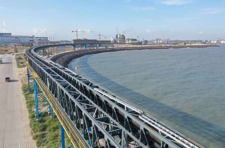 Conveyor system serving a coastal materials-handling facility